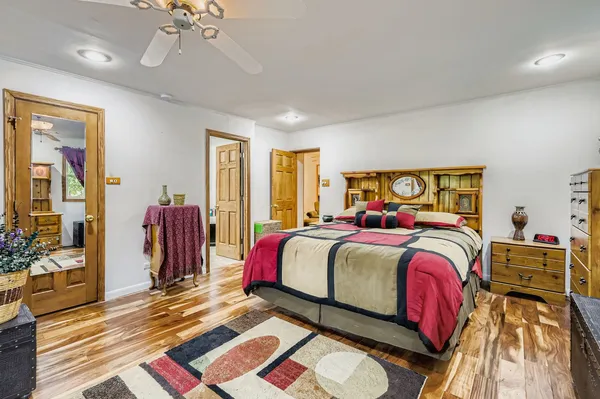 a bedroom with a bed and a mirror