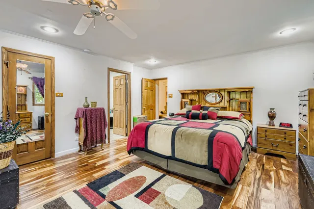 a bedroom with a bed and a mirror