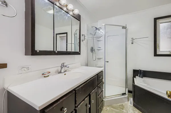 a bathroom with a sink a mirror and a shower