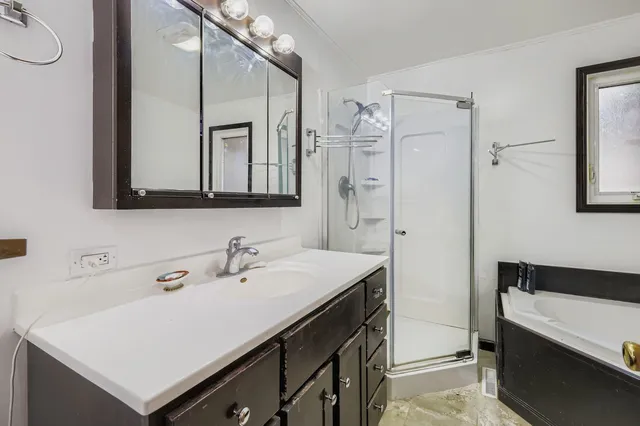 a bathroom with a sink a mirror and a shower