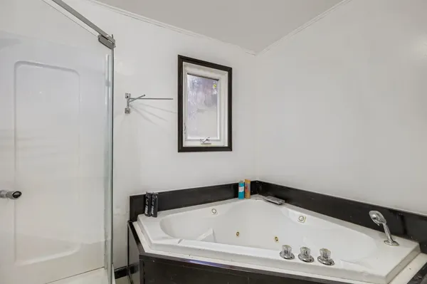 a bathroom with a tub and a shower