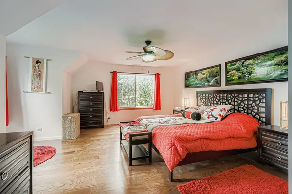 a bedroom with a bed and a chandelier