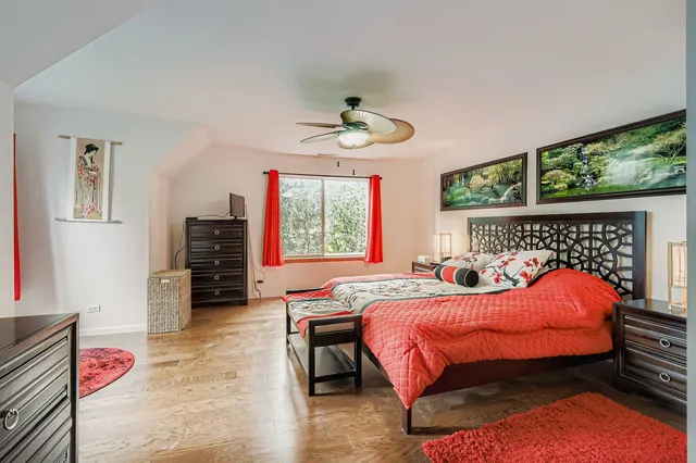 a bedroom with a bed and a chandelier