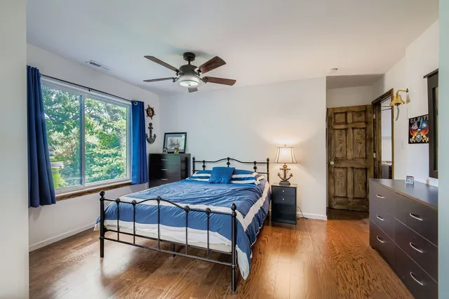 a bedroom with a bed and a table in it