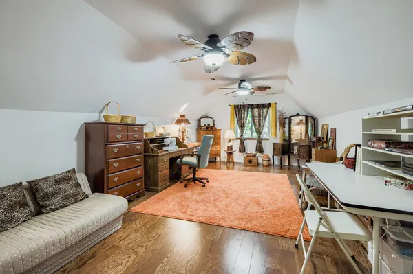 a living room with furniture a chandelier and a flat screen tv