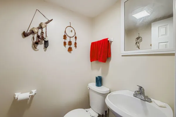 a bathroom with a toilet sink and mirror