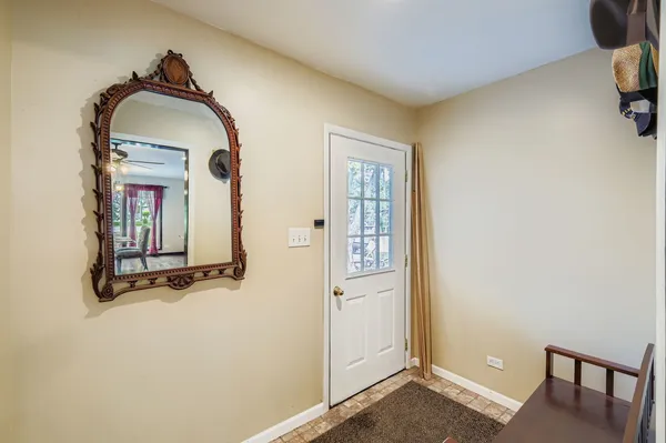 a view of a livingroom with wooden floor and a bathroom