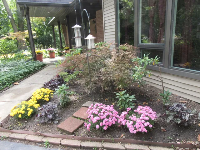 a front view of a house with a yard and flowers