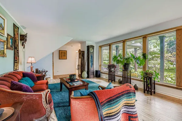 a living room filled with furniture and floor to ceiling windows