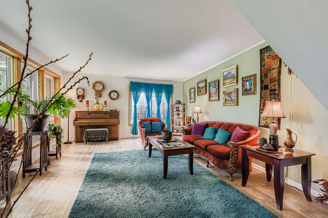 a living room with furniture a fireplace and a window