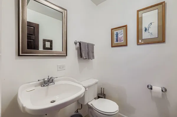 a bathroom with a sink mirror and toilet