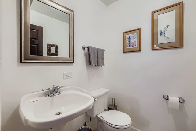 a bathroom with a sink mirror and toilet