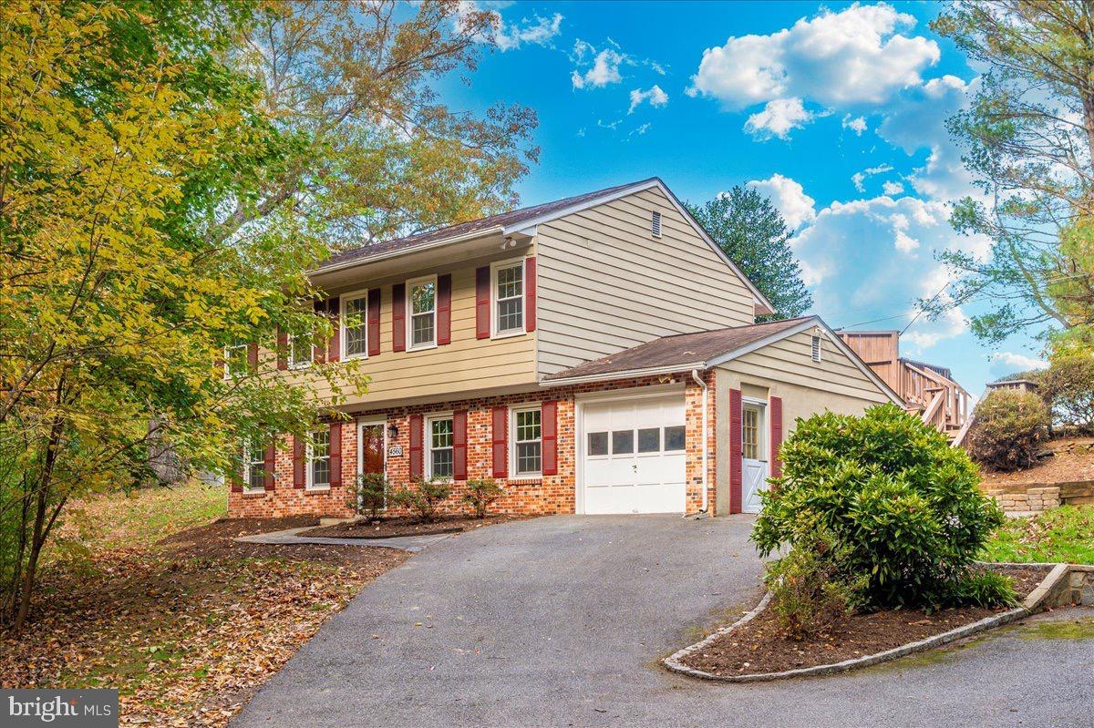 a view of a white house with large windows and a table and chairs