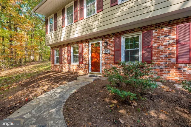 a front view of a building with a garden
