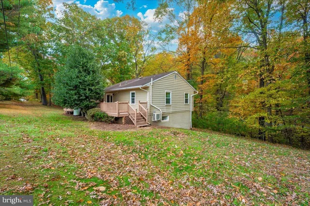 a view of backyard with a deck and wooden floor