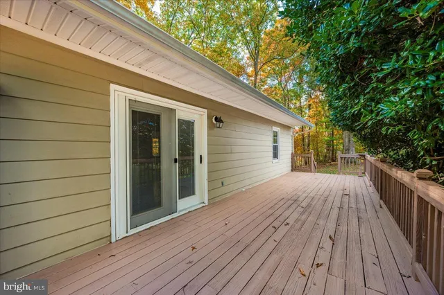 a front view of a house with yard and parking