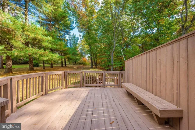 a view of an house with backyard and trees