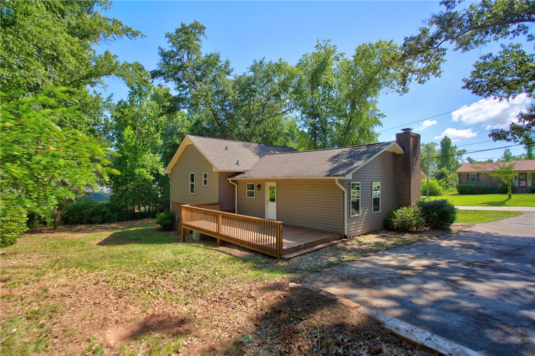 712 Beech Drive Seneca, SC 29678 - Photo 4 of 41 A welcoming home with a spacious deck offers comfortable outdoor living.
