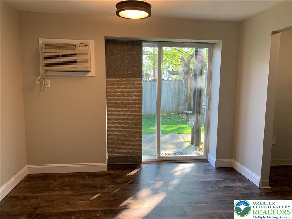 526 Broad Street, Unit 1 Emmaus, PA 18049 - Photo 4 of 15 a view of an empty room with wooden floor and a window