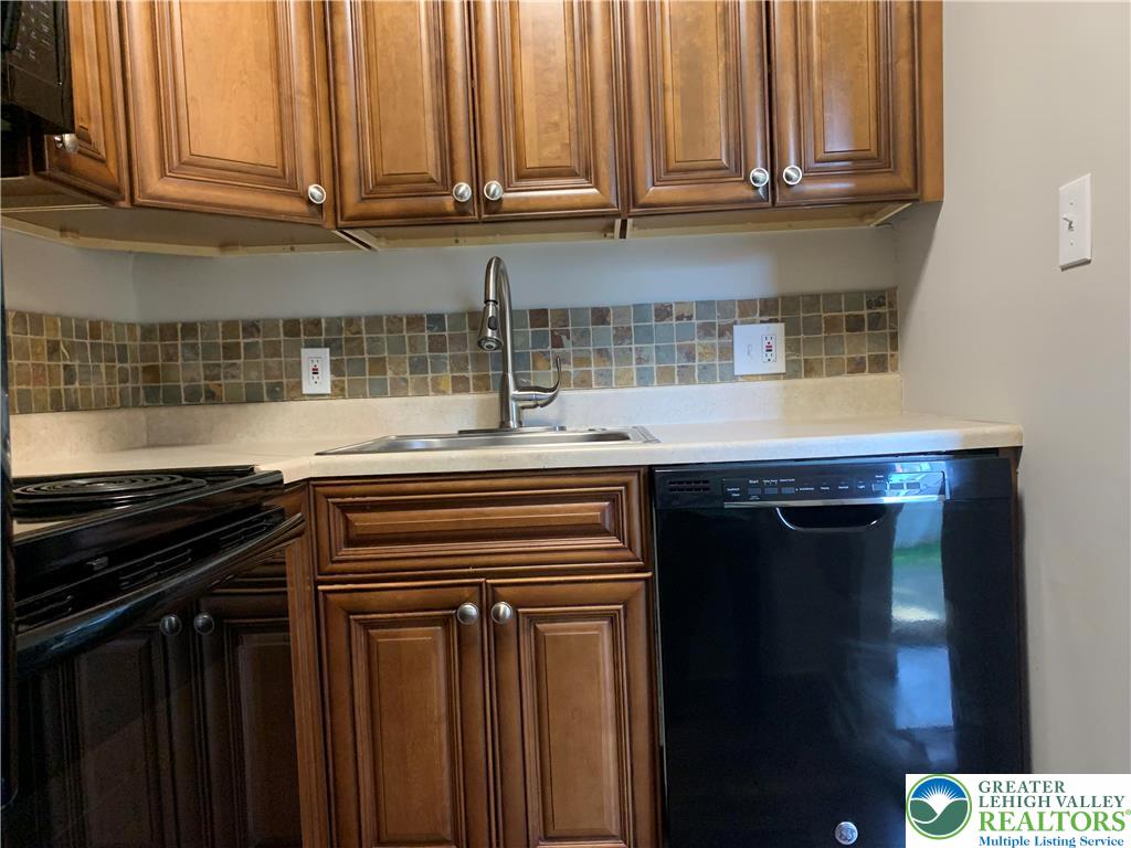 526 Broad Street, Unit 1 Emmaus, PA 18049 - Photo 6 of 15 a kitchen with stainless steel appliances a stove and a microwave