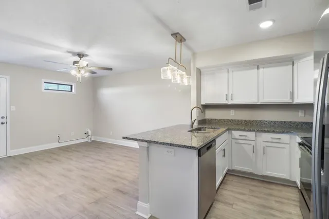 a kitchen with a sink cabinets and window
