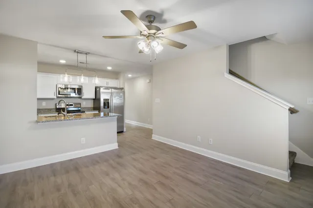 a view of kitchen with refrigerator and window