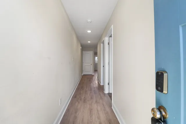 a view of hallway with wooden floor