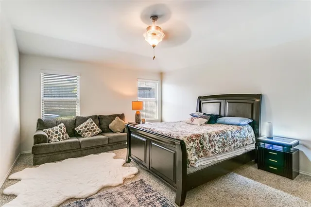 a bedroom with a bed couch and window