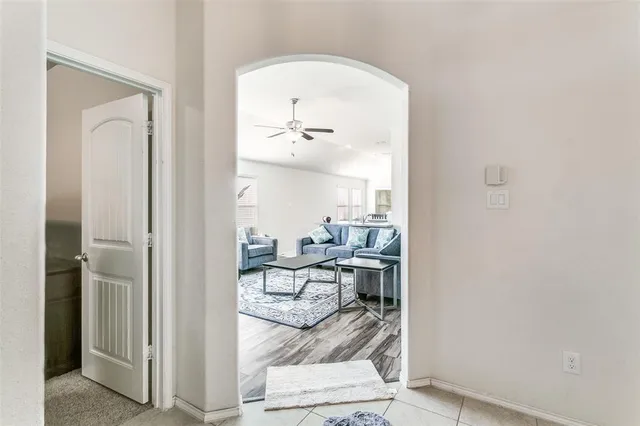 a living room with furniture and a mirror
