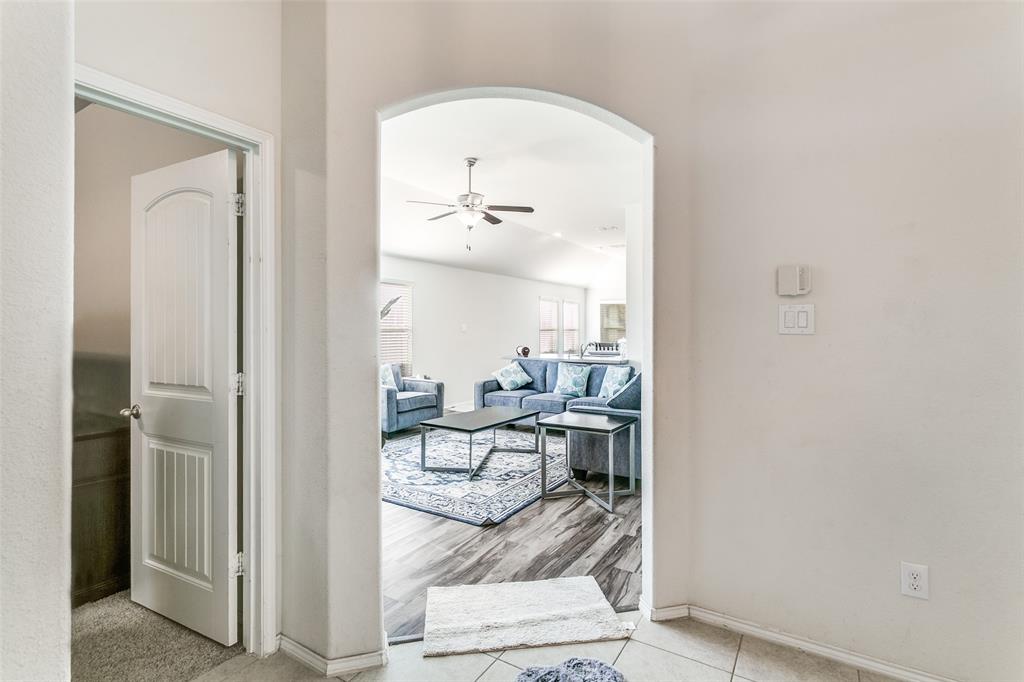 14549 Serrano Ridge Road Fort Worth, TX 76052 - Photo 5 of 25 a living room with furniture and a mirror