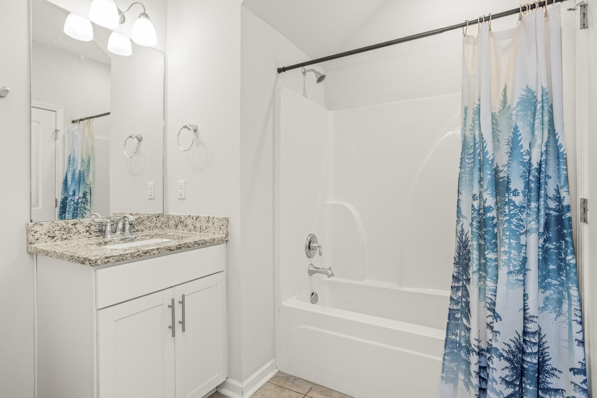 4221 Grapevine Loop Smyrna, TN 37167 - Photo 20 of 27 a bathroom with a granite countertop sink a mirror a vanity and a shower