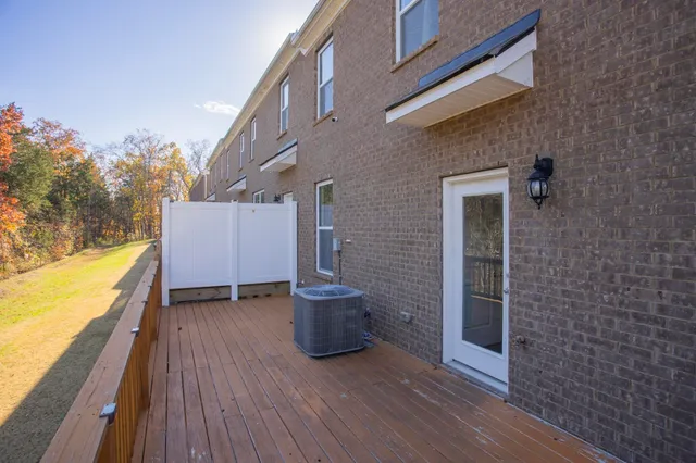 a view of an outdoor space with wooden floor and a yard