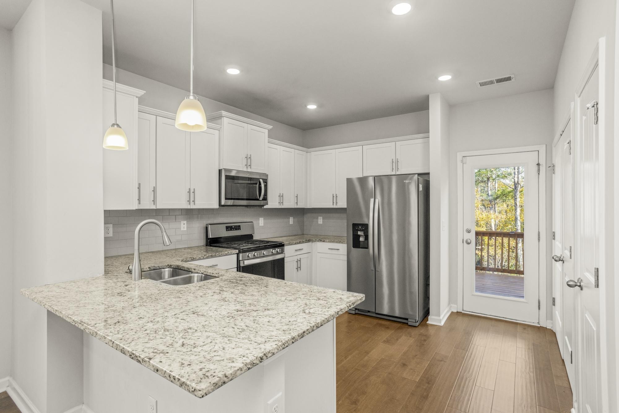 4221 Grapevine Loop Smyrna, TN 37167 - Photo 4 of 27 a kitchen with stainless steel appliances granite countertop a sink refrigerator and microwave