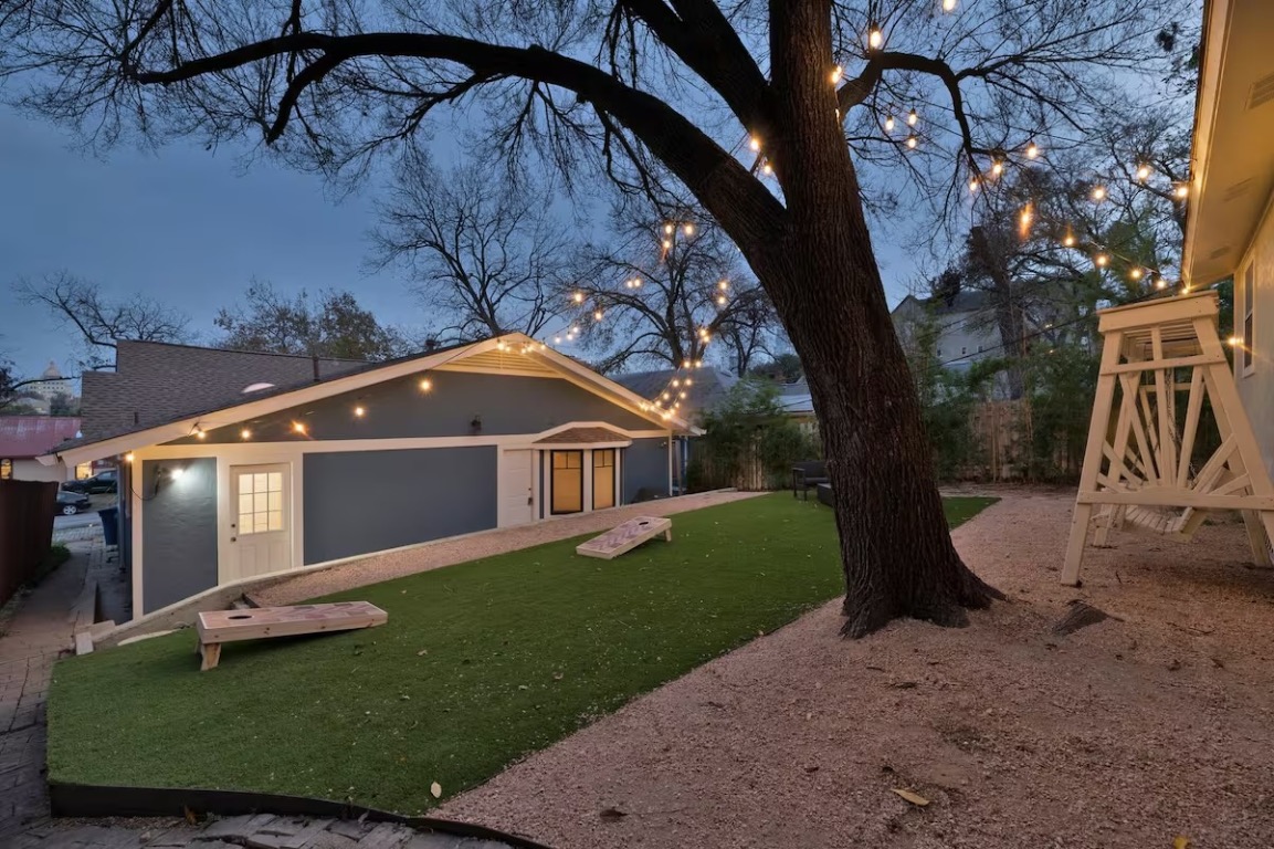 1212 Baylor Street Austin, TX 78703 - Photo 12 of 14 View of front facade featuring a front yard and stucco siding