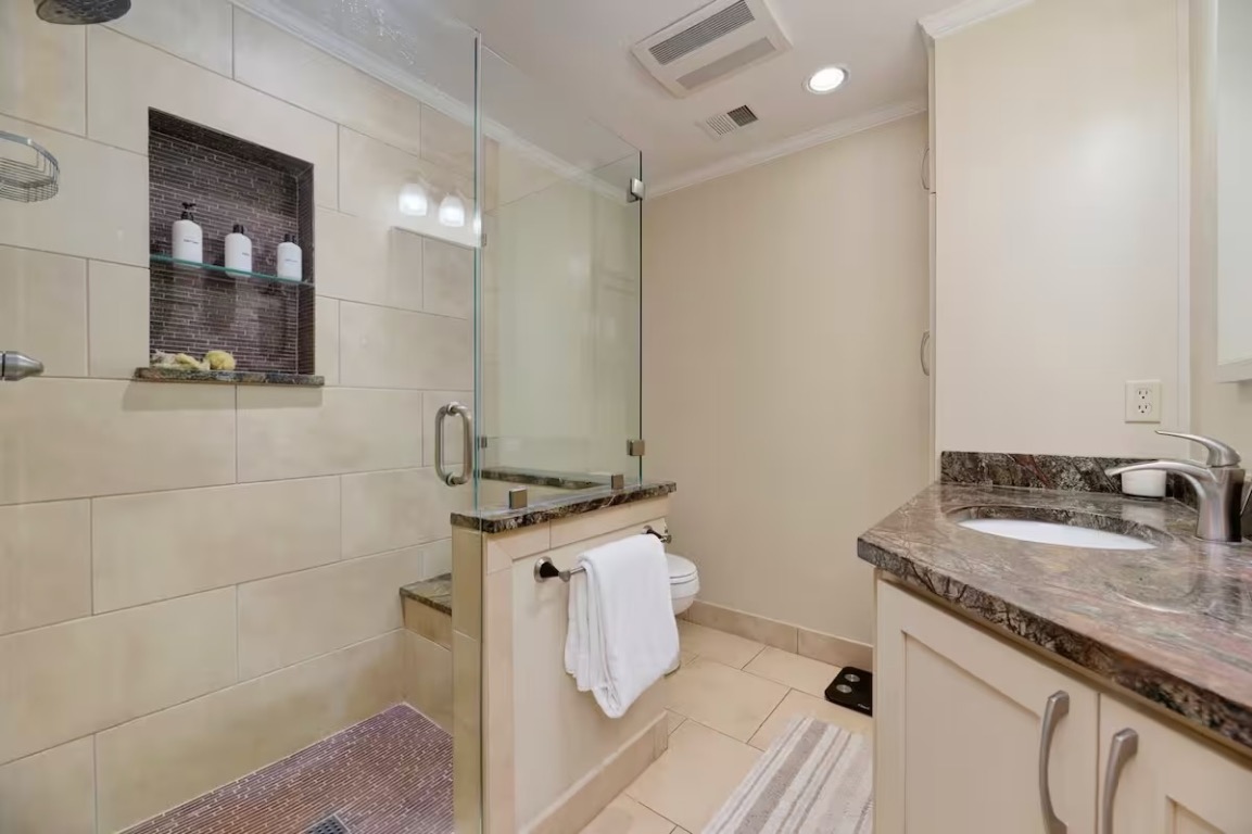1212 Baylor Street Austin, TX 78703 - Photo 10 of 14 Full bathroom featuring vanity, crown molding, a stall shower, light tile patterned floors, and recessed lighting