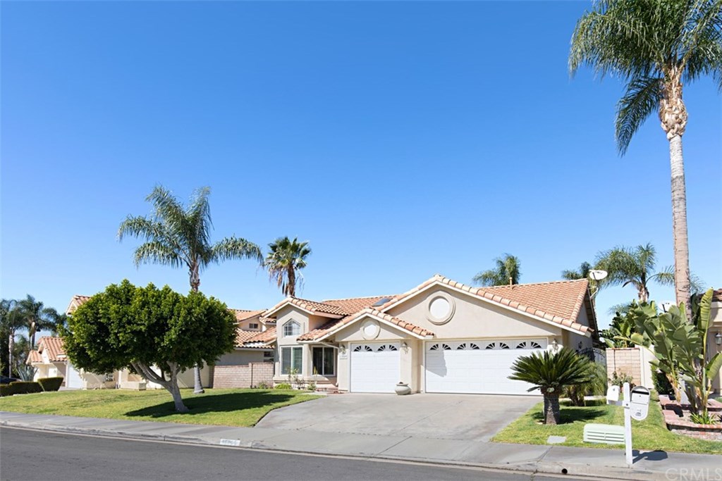 Exterior front view features 3 car garage, tile roof, concrete driveway