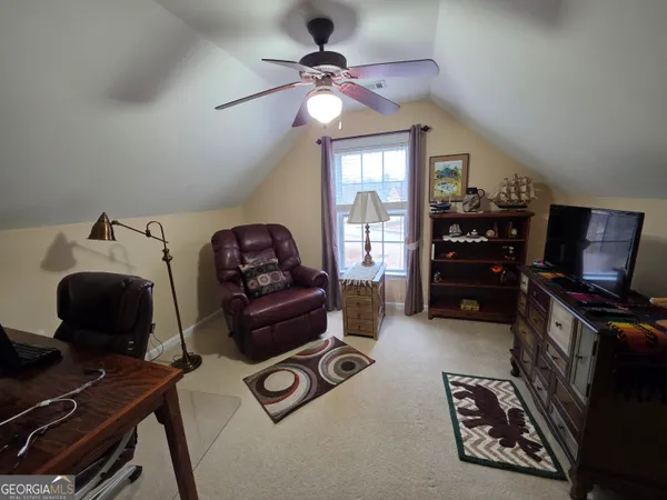 a bedroom with furniture and a window
