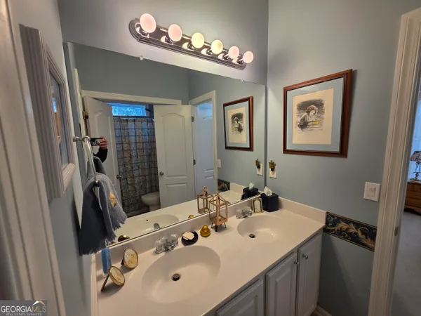 a bathroom with a sink mirror and a window