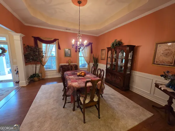 a view of a dining room with furniture and wooden floor