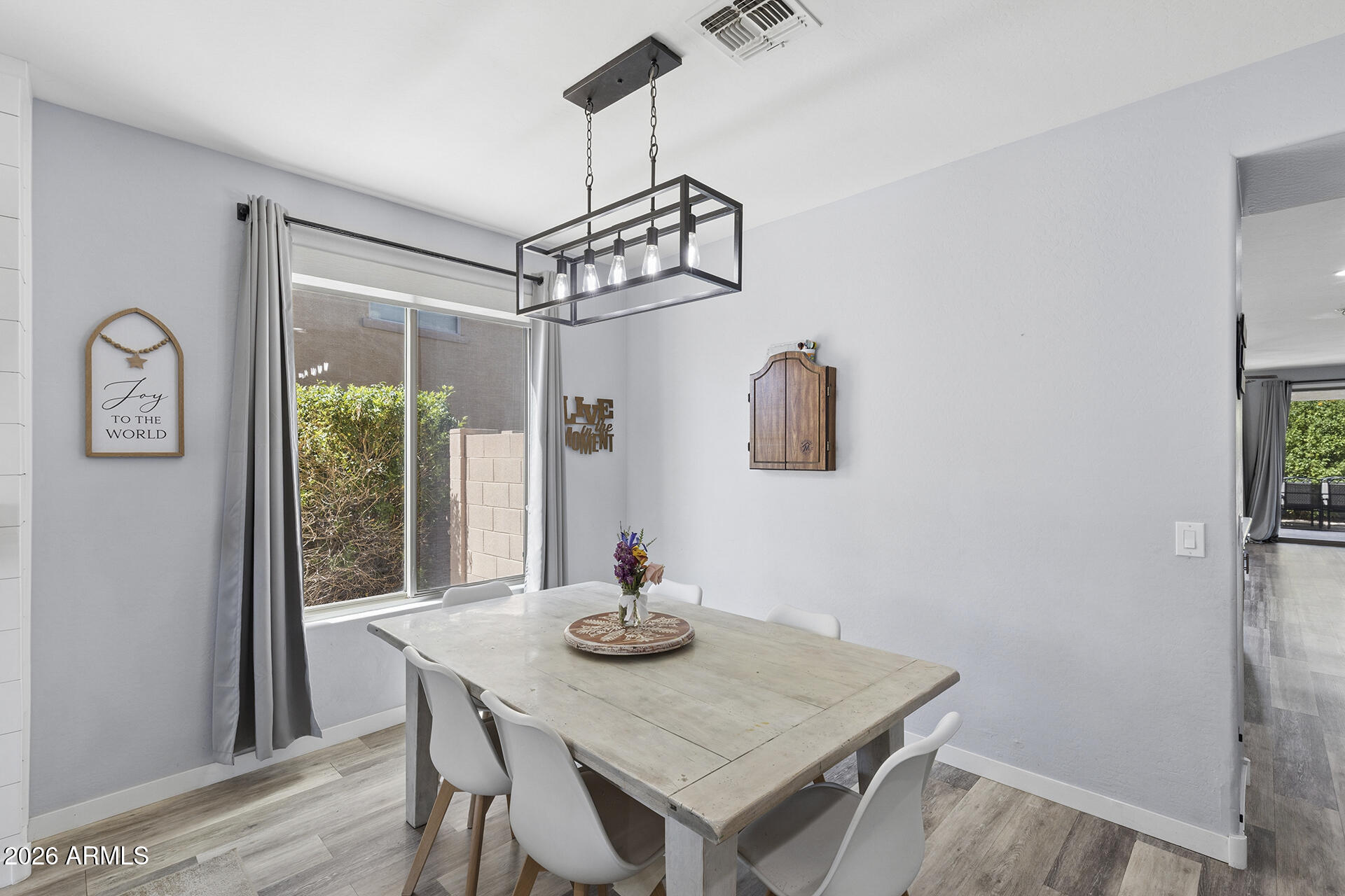 6848 West Ridgeline Road Peoria, AZ 85383 - Photo 12 of 71 a view of a dining room with furniture window and wooden floor