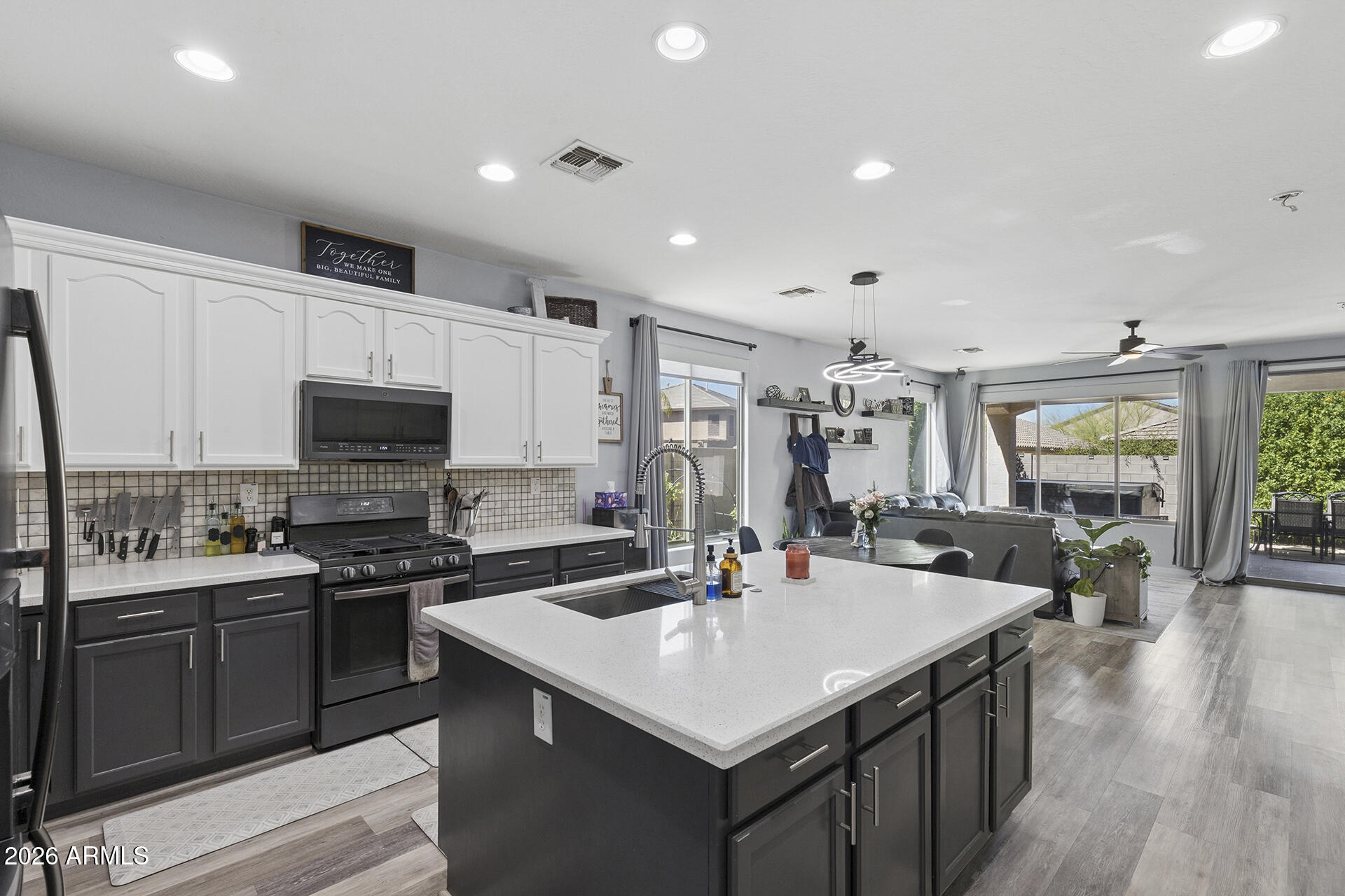 6848 West Ridgeline Road Peoria, AZ 85383 - Photo 13 of 71 a kitchen with a sink a counter top space stainless steel appliances and cabinets