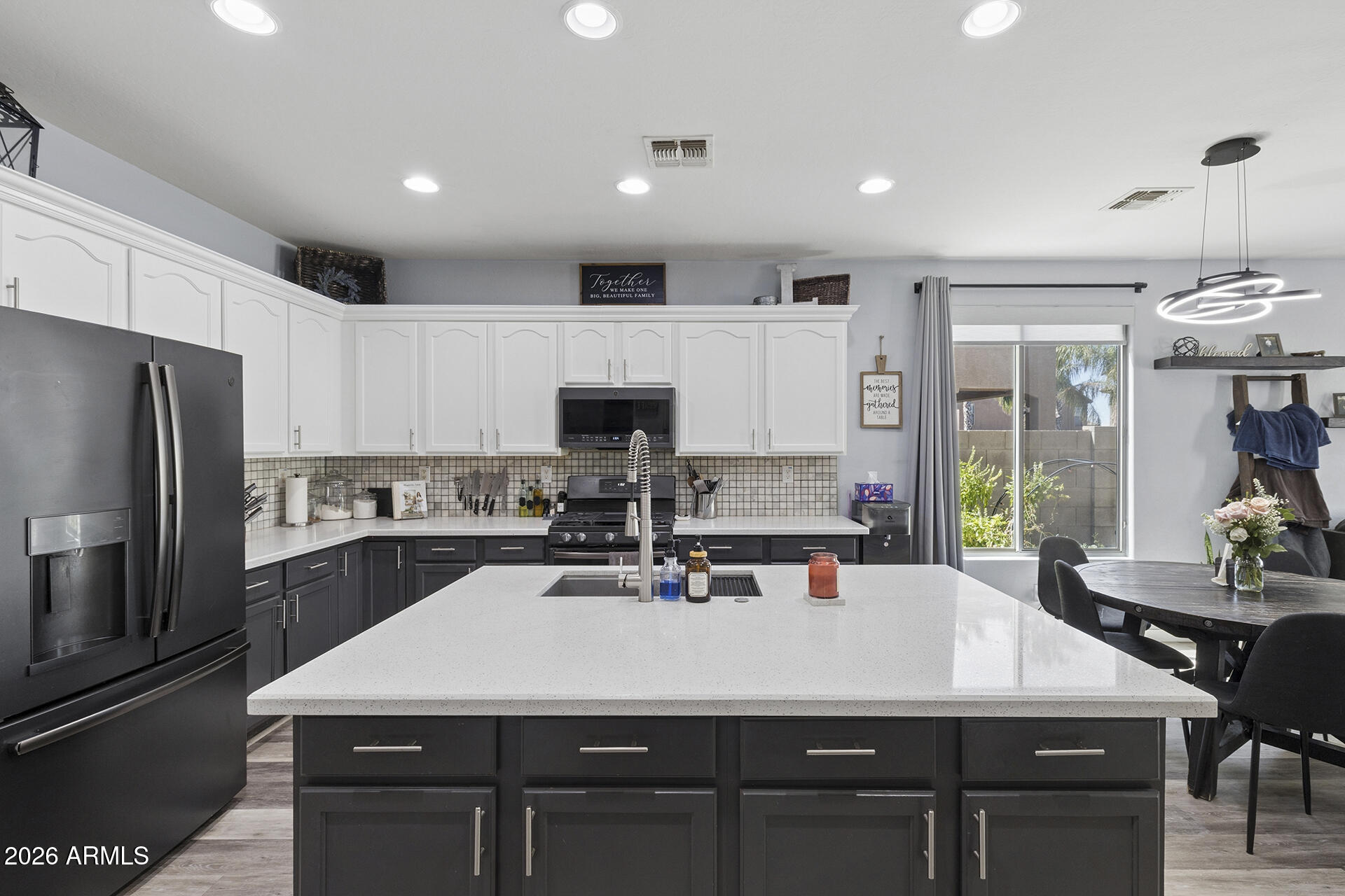 6848 West Ridgeline Road Peoria, AZ 85383 - Photo 14 of 71 a kitchen with a table chairs refrigerator and microwave