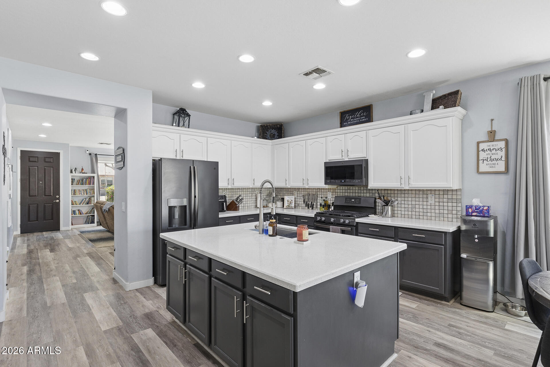 6848 West Ridgeline Road Peoria, AZ 85383 - Photo 15 of 71 a kitchen that has a lot of cabinets a sink and a counter top space in it
