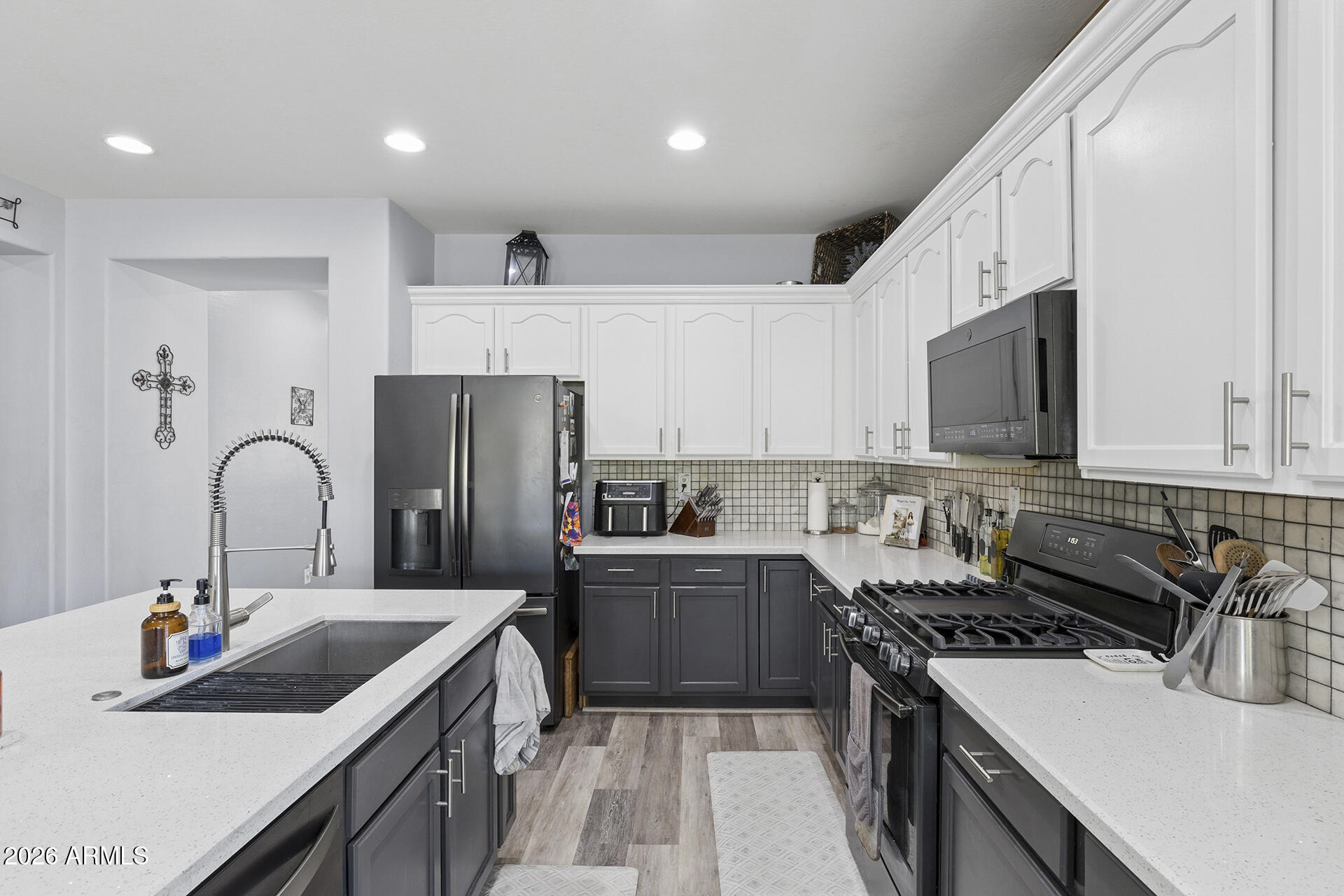 6848 West Ridgeline Road Peoria, AZ 85383 - Photo 16 of 71 a kitchen with stainless steel appliances granite countertop a sink stove and refrigerator