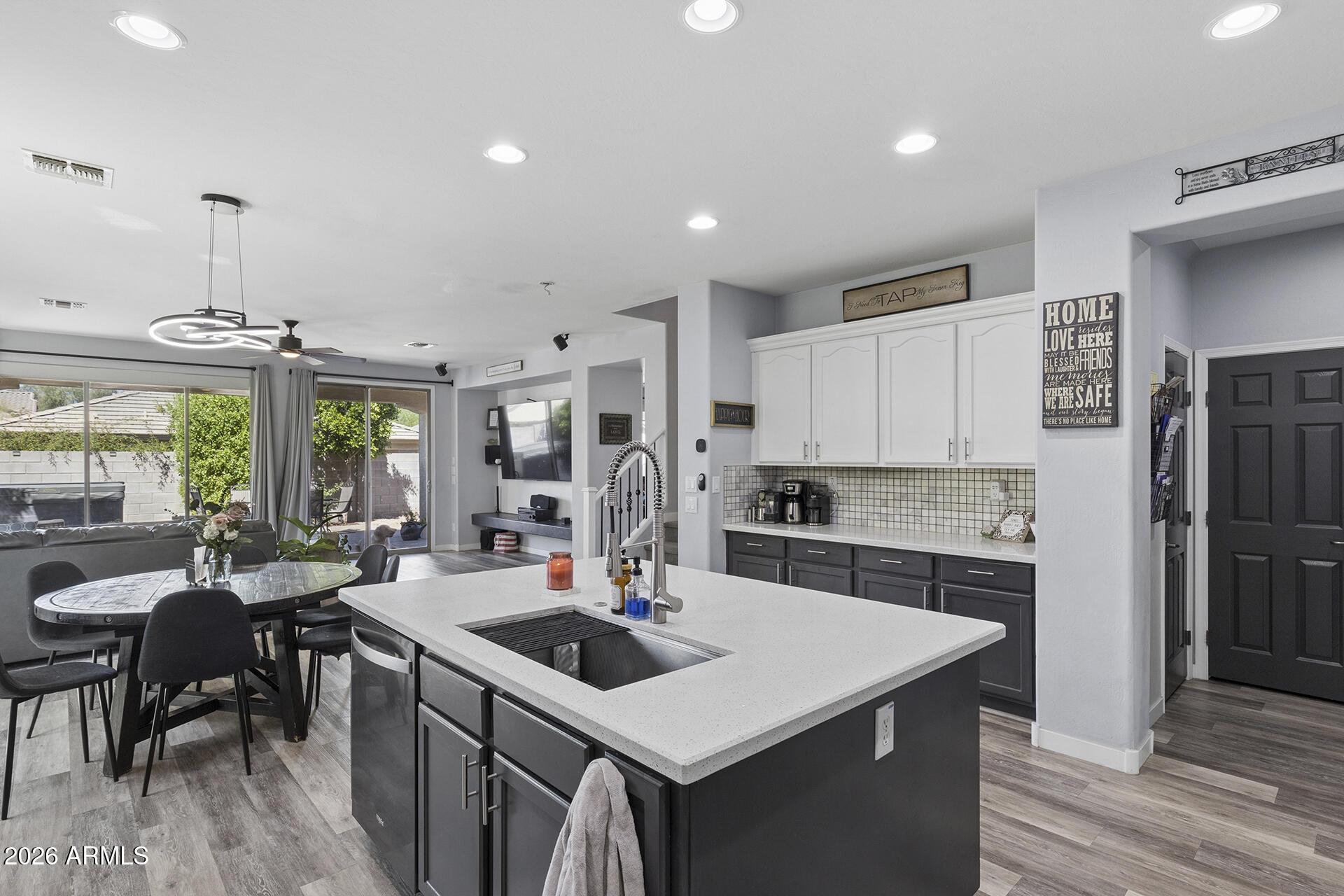 6848 West Ridgeline Road Peoria, AZ 85383 - Photo 17 of 71 a kitchen with a stove a refrigerator and a dining table with wooden floor