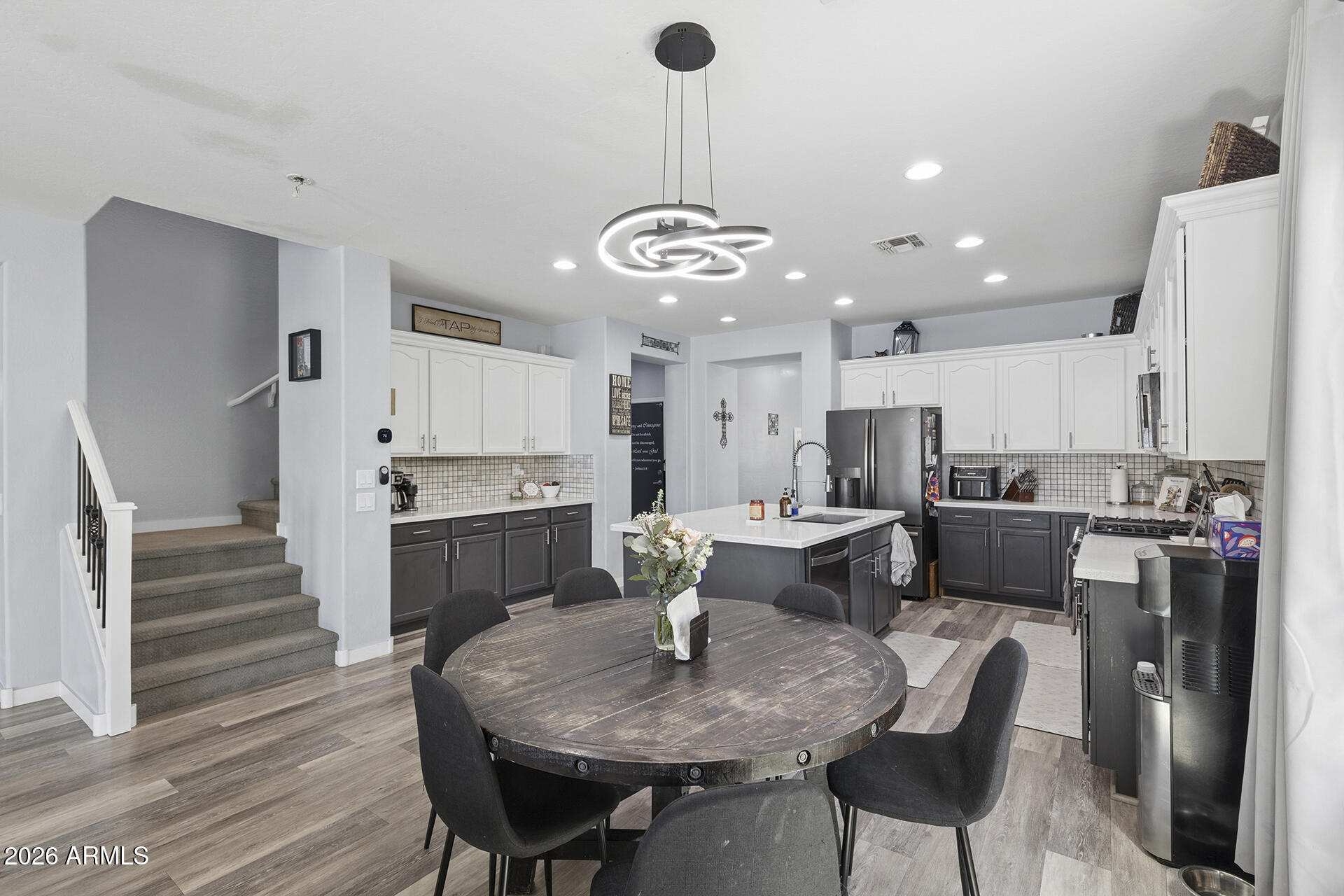 6848 West Ridgeline Road Peoria, AZ 85383 - Photo 22 of 71 a living room with stainless steel appliances furniture a dining table and kitchen view