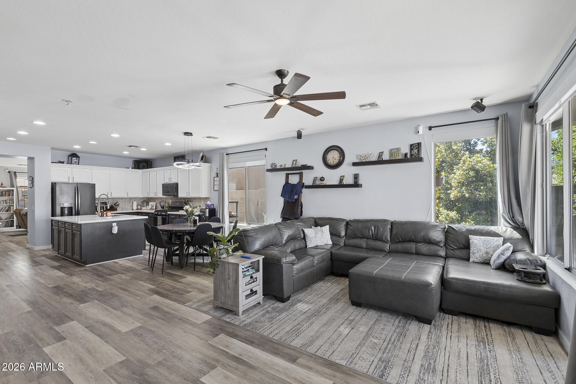 6848 West Ridgeline Road Peoria, AZ 85383 - Photo 24 of 71 a living room with furniture kitchen area and a wooden floor