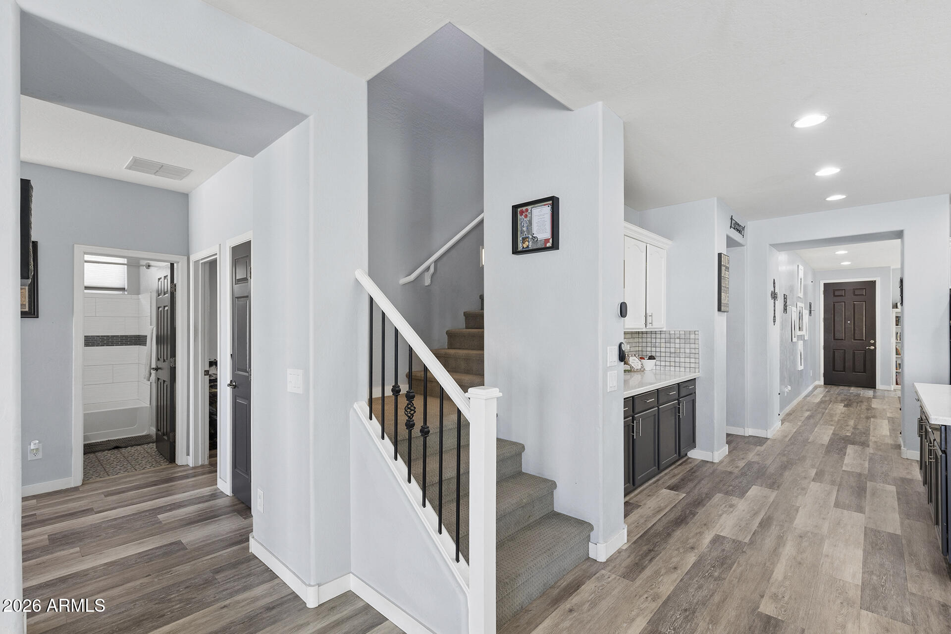 6848 West Ridgeline Road Peoria, AZ 85383 - Photo 27 of 71 a view of a hallway with wooden floor and staircase