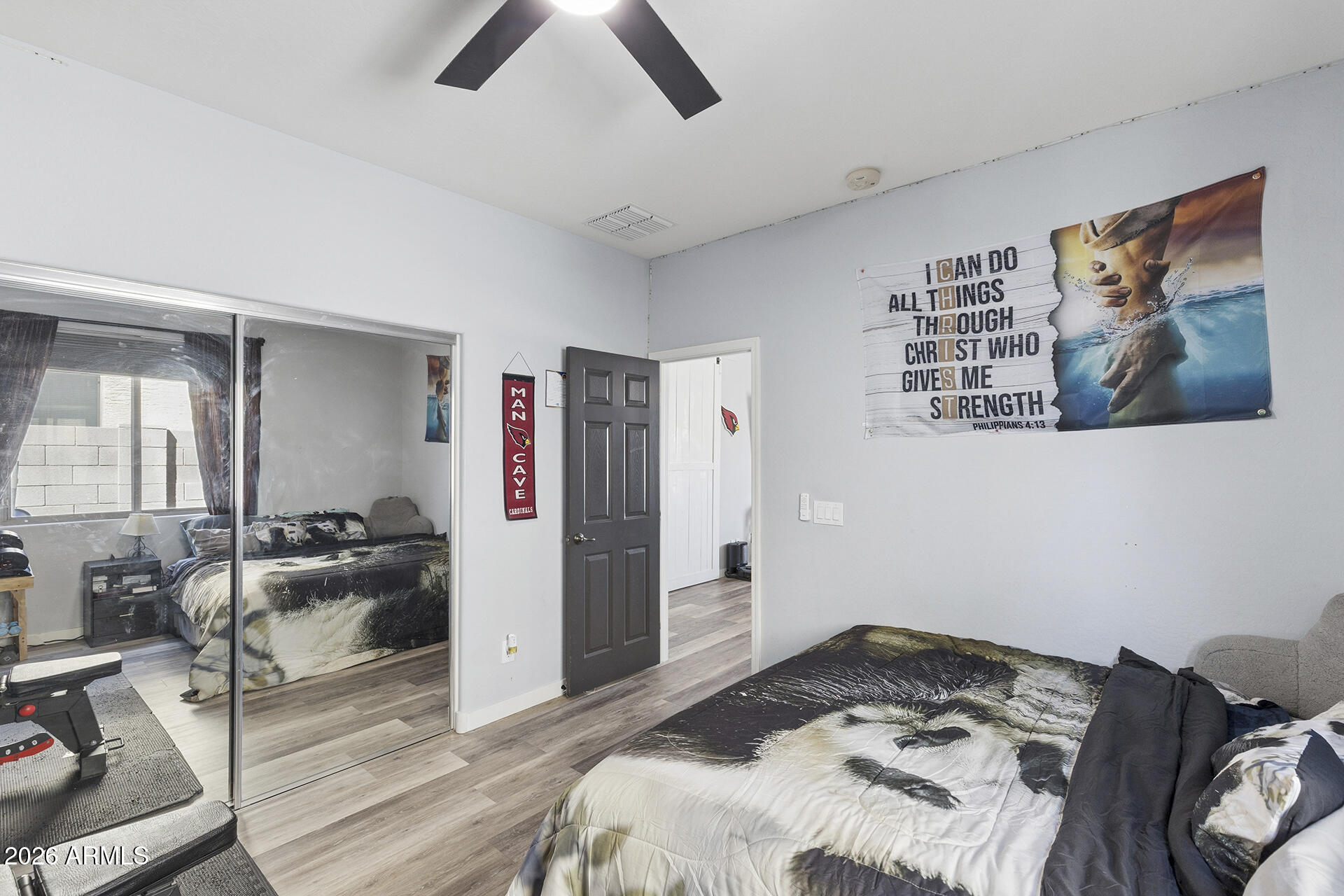 6848 West Ridgeline Road Peoria, AZ 85383 - Photo 29 of 71 a bedroom with a bed and wooden floor
