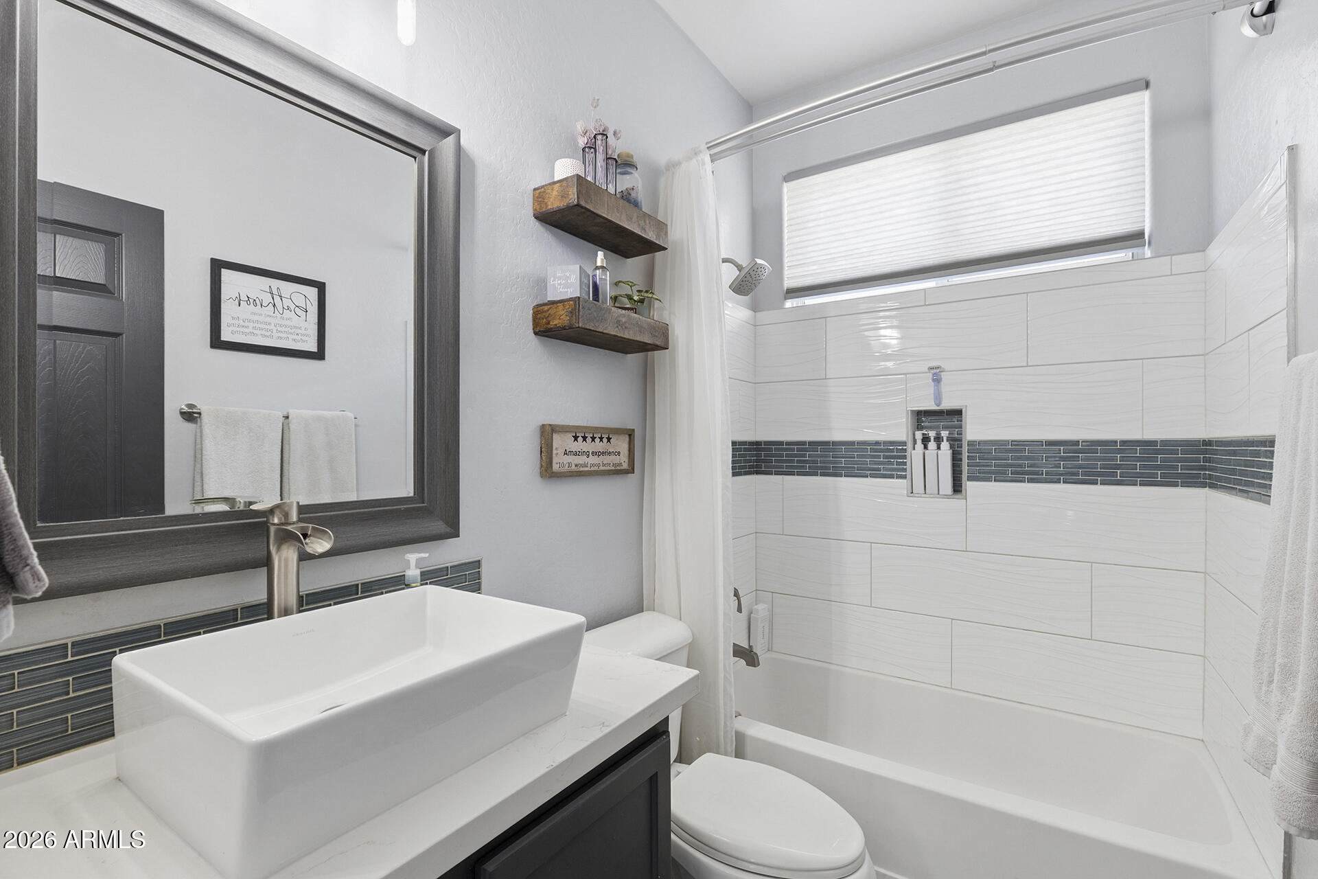 6848 West Ridgeline Road Peoria, AZ 85383 - Photo 30 of 71 a bathroom with a sink a toilet and shower